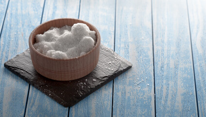 Rock salt in a wooden bowl. For designers.