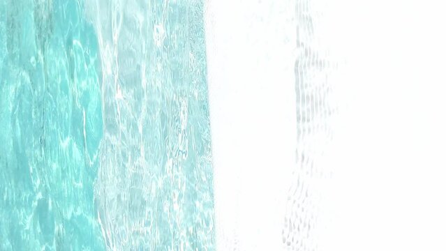A woman takes citrus lemonade while relaxing by the pool on vacation in the summer