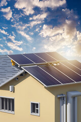 Fototapeta premium Photovotaic Solar Panel Instalation at a roof at suset.