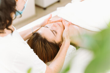 Lymphatic drainage facial and collar zone massage by professional massage therapist in clinic