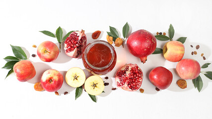Autumn banner with honey, apples, pomegranates, flowers, dried fruits on a light background with place for text, composition for the Jewish holiday Rosh Hashan, Hello autumn and thanksgiving day 