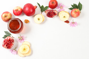 Autumn banner with honey, apples, pomegranates, flowers, dried fruits on a light background with...