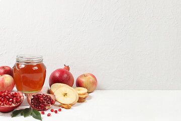 Autumn banner with honey, apples, pomegranates, flowers, dried fruits on a light background with place for text, composition for the Jewish holiday Rosh Hashan, Hello autumn and thanksgiving day 