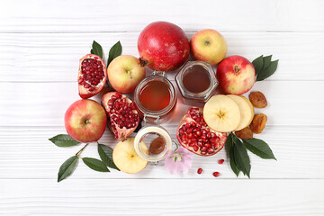 Autumn banner with honey, apples, pomegranates, flowers, dried fruits on a light background with...
