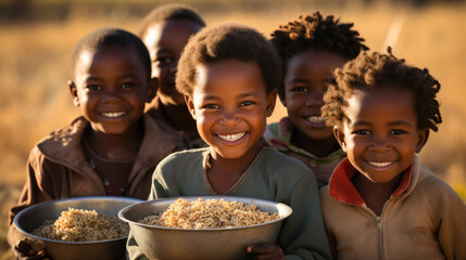 Portrait of happy african kids holding bowl with rice in field Jinja, Uganda. - obrazy, fototapety, plakaty