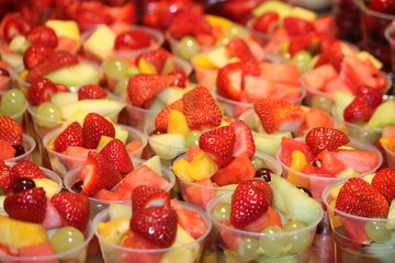 A Background Display of Fresh Fruit Salad Desserts.
