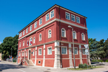Historical red building right next to the  Park of Heads Zadar in the state of Zadar Croatia