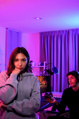 Asian girlfriend bored and and sulk boyfriend gamer always playing video game online with his friends instead of dating together in holiday weekend at entertainment neon light room at home