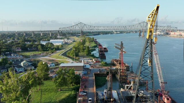 Drone Footage of Mississippi River with Crescent City Bridge, Cargo Docks and Cranes