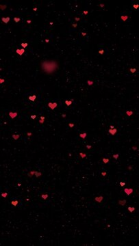 Red heart shapes motion on clean black vertical animation background. Seamless looping.