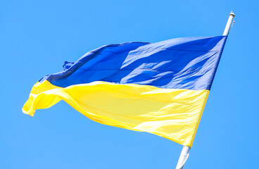 The national flag of Ukraine (yellow and blue) on the flagpole during the day