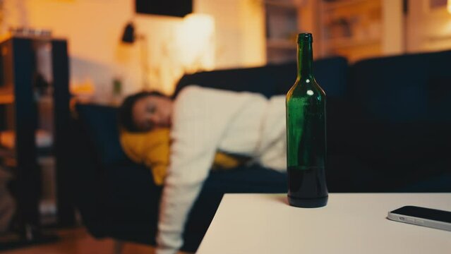 Young woman sleeping after drinking wine, life problems, alcohol addiction