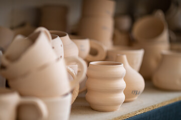 Pottery shelf in studio, creative store clay products, collection and display in workshop.