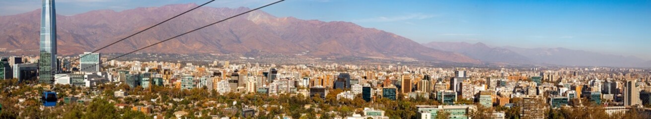 panorama of the city of Santiago Chile with its buildings, cable car and the Andes mountain range