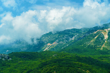 beautiful mountains, summer landscape, clouds, forest on the hillsides