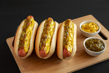 Homemade Gourmet Hot Dogs with Sweet Relish and Mustard, side view.