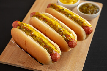 Homemade Gourmet Hot Dogs with Sweet Relish and Mustard, side view. Close-up.