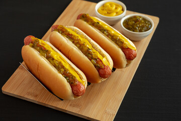 Homemade Gourmet Hot Dogs with Sweet Relish and Mustard, side view. Close-up.