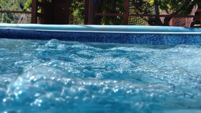 A serene video depicting the gentle waves that grace a summer pool