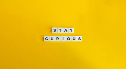 Stay Curious Phrase on Letter Tiles on Yellow Background. Minimal Aesthetic.
