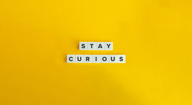Stay Curious Phrase on Letter Tiles on Yellow Background. Minimal Aesthetic.