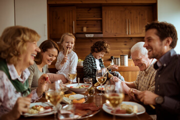 Multigenerational family having lunch together in the dining room at home