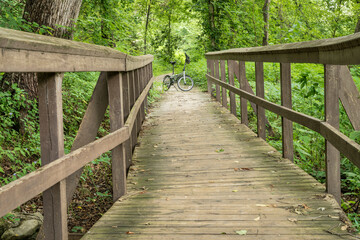 folding bike and footbridge - Katy Trail (side nature trail) near Rocheport, Missouri, in summer scenery