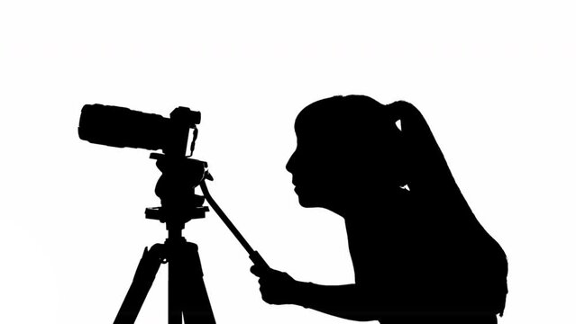 Videographer girl silhouette with camera and tripod. black and white mask