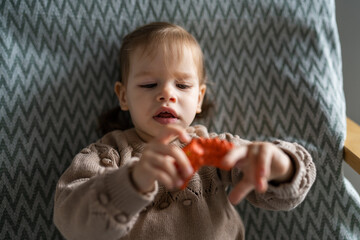 One small Caucasian girl little child toddler hold finger puppet toy