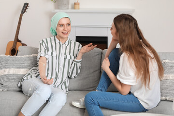 Obraz premium Teenage girl undergoing chemical therapy course with her sister at home