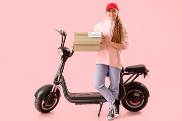 Fototapeta na wymiar Female courier with parcels and scooter on pink background
