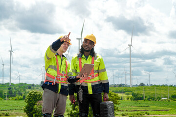 Engineers are inspecting construction of WIND TURBINE FARM. WIND TURBINE with an energy storage...