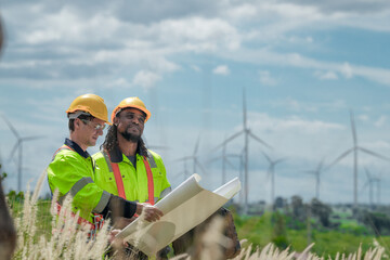 Engineers are inspecting construction of WIND TURBINE FARM. WIND TURBINE with an energy storage...