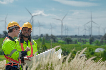 Engineers are inspecting construction of WIND TURBINE FARM. WIND TURBINE with an energy storage...