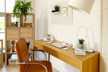 Modern workplace with gadgets in light office