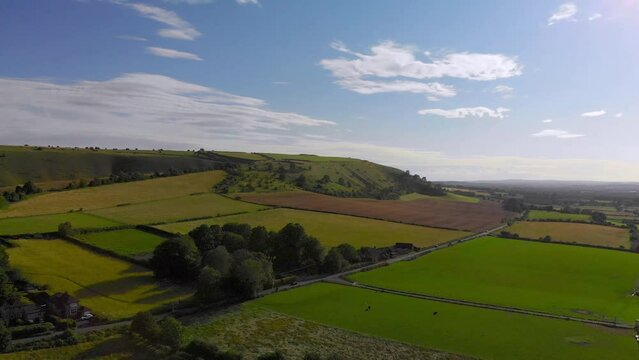 Slow transverse flight over a patchwork of fields and roads in England.