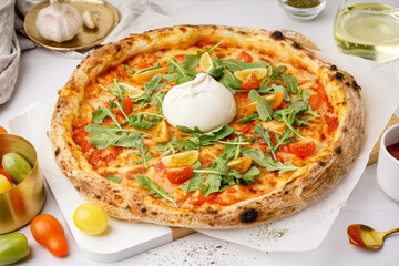 Tasty pizza with Burrata cheese on grey background