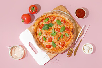 Board with tasty pizza Margarita and bowl of mozzarella on pink table