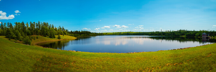 Tranquil summer landscape and cloudscape over Town of Truro Reservoir at Victoria Park in Truro, Nova Scotia, Canada