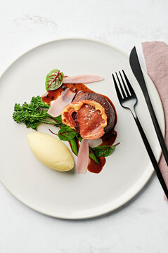 Eye fillet, mashed potato, charred broccolini, black truffle jus, pickled shallot petals, crisp pancetta