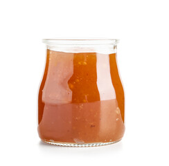 Jar with sweet apricot jam on white background