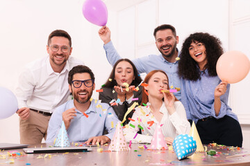 Coworkers having fun during office party indoors