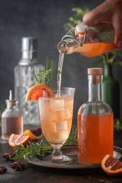 Cocktail with Blood Orange Syrup being poured_DARK