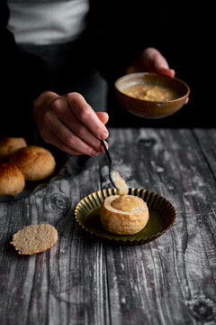 Semlor Buns on Wood Backdrop with icing sugar on tray with hands