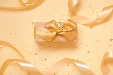 Composition with beautiful gift box, ribbons and sequins on color background