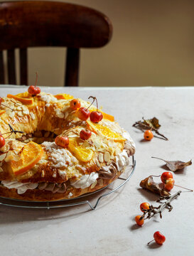 traditional Christmas cake roscon de reyes with figurines of the Three Kings with cream, chocolate and turron, Spanish and Mexican tradition