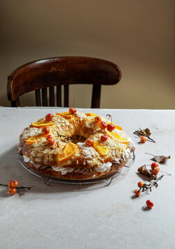 traditional Christmas cake roscon de reyes with figurines of the Three Kings with cream, chocolate and turron, Spanish and Mexican tradition