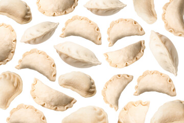 Many raw dumplings (varenyky) falling on white background