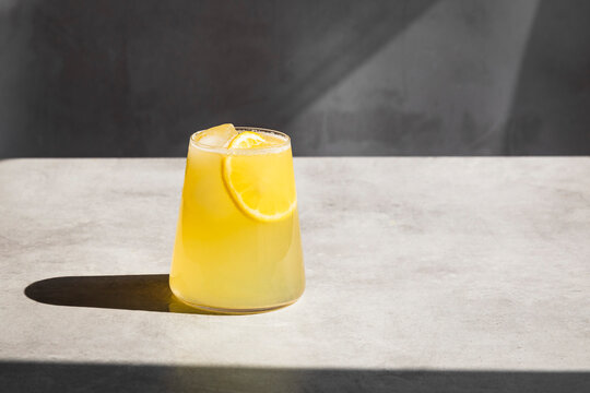 Homemade lemonade with ice and lemon slices in a glass.
