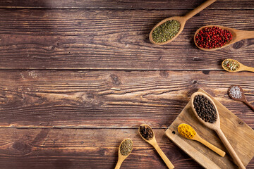 Various spices and seasonings in wooden spoons.